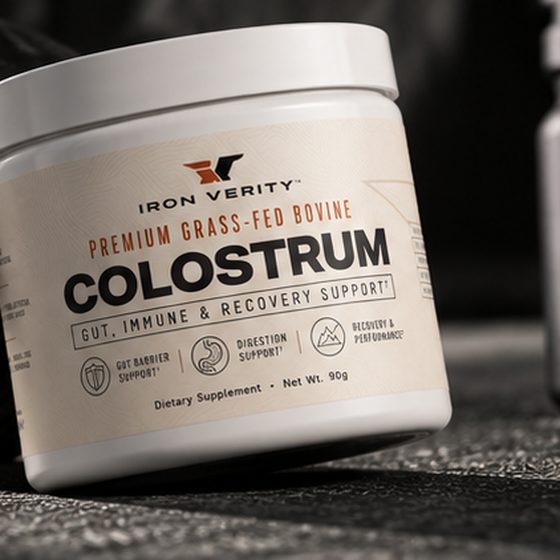 Iron Verity Bovine Colostrum jar beside a 45 lb weight plate.